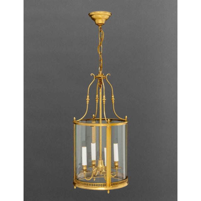 Regency Style Gilt Brass Hanging Lantern, with four candlestick form light fittings. 39" H x 12.25" Diameter. Provenance:...