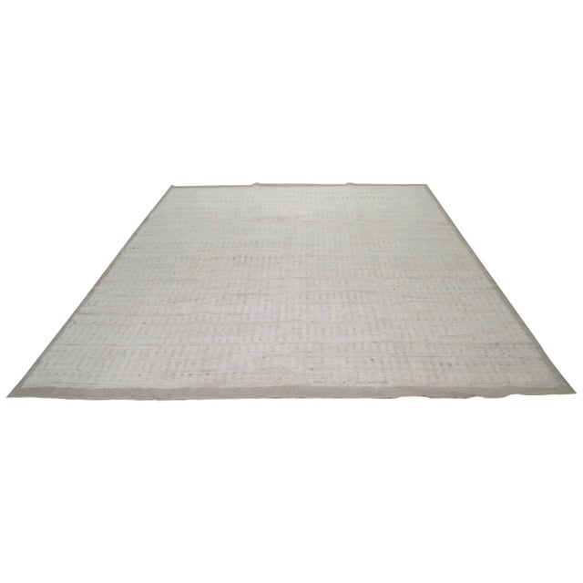 Hand-knotted with care using traditional rug making techniques, this wool rug blends timeless craftsmanship with a modern...