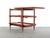 An exquisite design by Poul Hundevad. Constructed from teak wood and set on petite minimal casters with brass accents. The...
