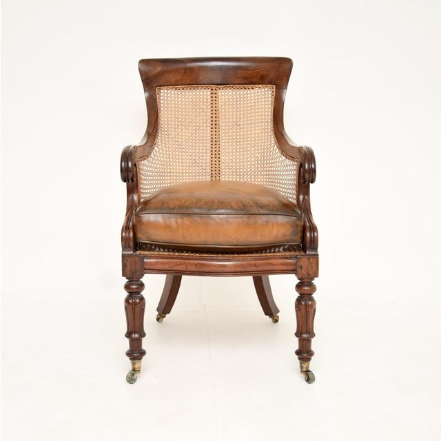 A beautiful and very well made antique William IV period leather caned armchair. This was made in England, it dates from...