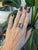 A dramatic 10.07-carat bi-color tourmaline blends two natural hues in a single emerald-cut stone, set in solid two-tone...
