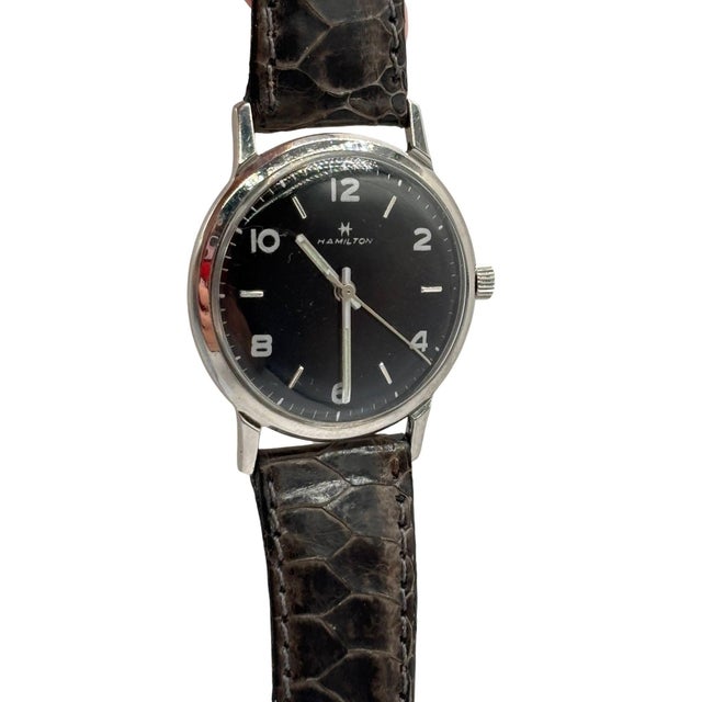 Mid-century Hamilton u246 Thinomatic manual wind wristwatch with black dial on leather band. This Hamilton Thinomatic...
