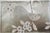 Elegant hand painted silver foil wallpaper sample featuring a delicate bird, blooming branches, and botanical leaves. The...
