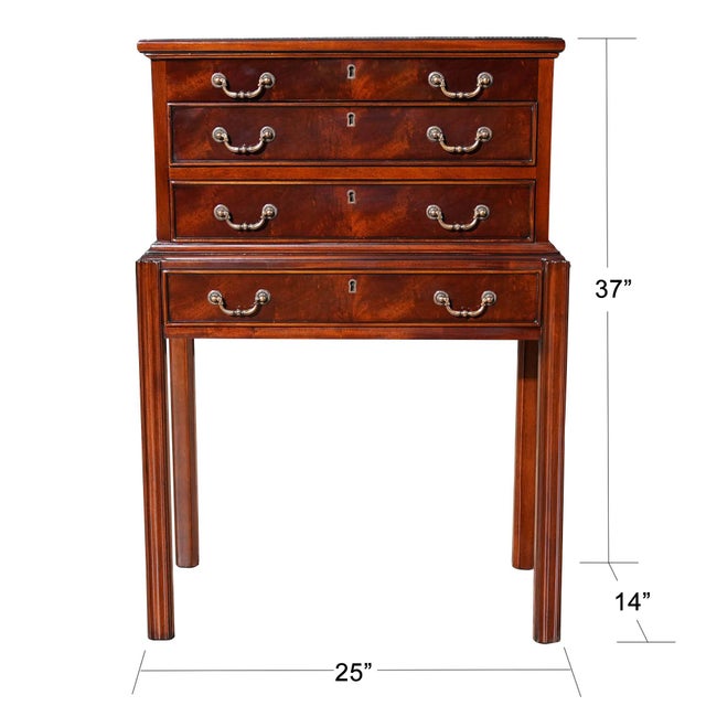 A small silver chest produced by Niagara Furniture resting on square and reeded legs with four drawers, the uppermost...