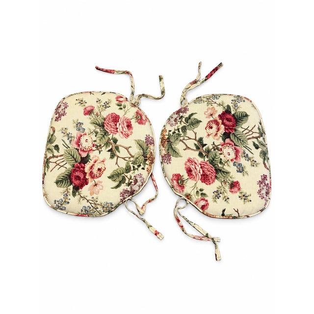 Sold as a pair, floral seat cushions with a romantic rose print in burgundy, pink, and cream, accented by green foliage...