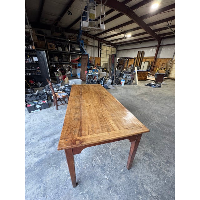 Quintessential 18th century country French provincial harvest table. The table features a plank top and peg joinery, and...