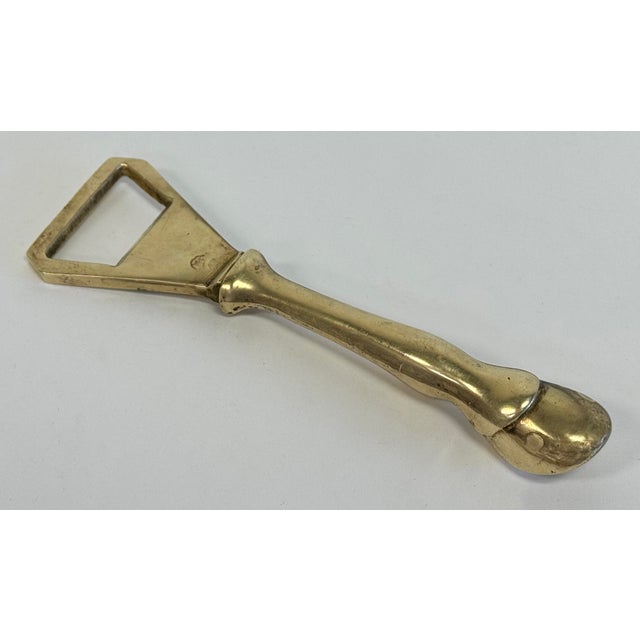 Vintage solid brass hoof motif bottle opener. Likely a horse hoof as appears to be a horseshoe to underside. Lovely patina.