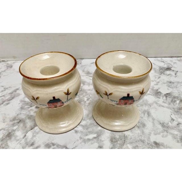 Petite pottery ceramic cottage style candleholders with hand painted house and floral motif.