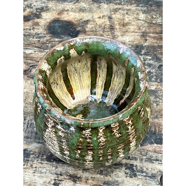 This vintage textured pottery lidded jar brings sculptural character and practical storage to a well-appointed interior....