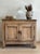 This antique French oak sideboard features solid oak construction, two paneled doors, original iron latch hardware, and a...