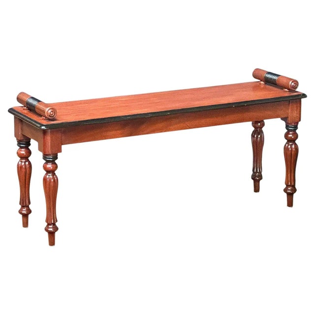 A fine English hall bench or window seat or stool of mahogany with ebonized accents from the Regency era, featuring turned...