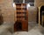 An English mahogany bookcase from the 19th century with glass doors, carved rosettes and acanthus leaves. Born in England...