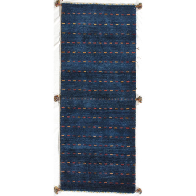Vintage hand-knotted Persian Lori wool runner with a deep blue field and evenly spaced horizontal dash motifs in red,...