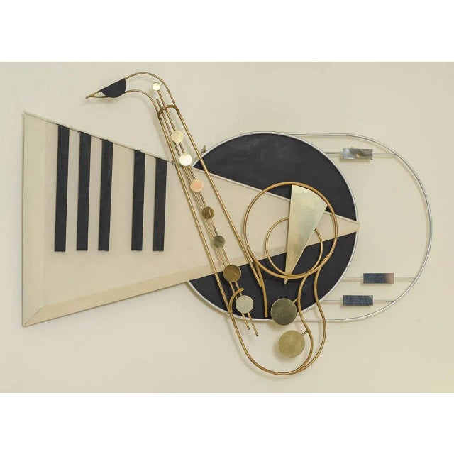 This rare wall-mounted piece by Curtis Jeré is made of brass and signed.
