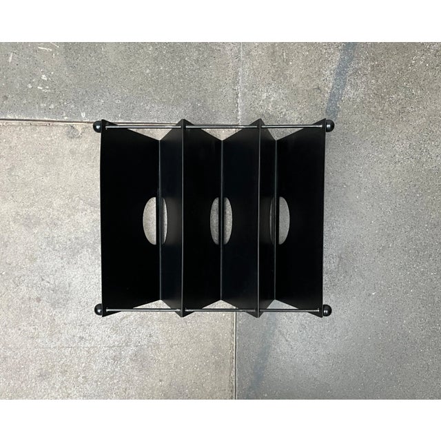 Postmodern magazine rack from Memphis based on a design by Ettore Sottsass from the 80s. Unfortunately there is no real...