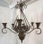 Timeless rustic gothic style six light chandelier. The vintage piece is made of iron with a brown- bronze factory finish....
