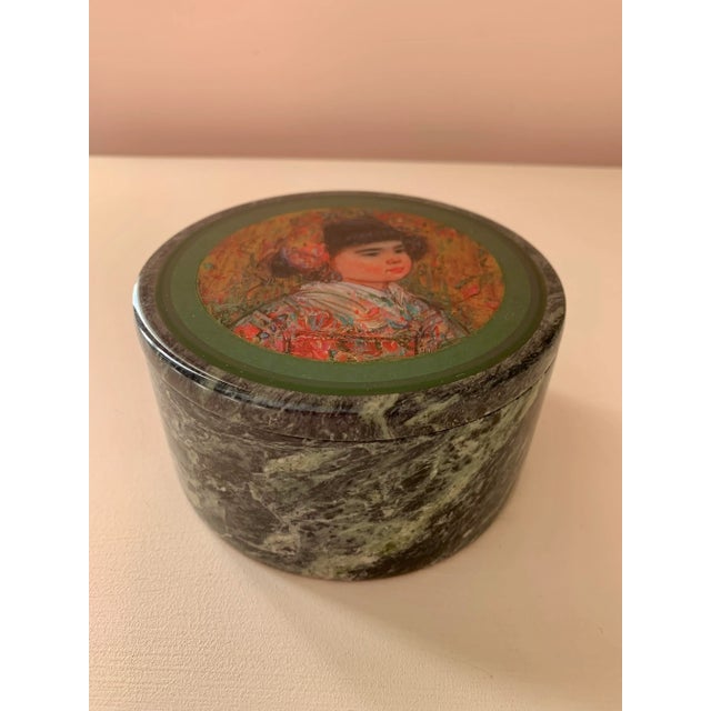 A carved green marble trinket box with an installed drawing women’s portrait. The box measures approximately 5” in...