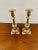 Pair of antique Victorian brass candlesticks having circular tops above a turned shaped column raised on a stepped shaped...