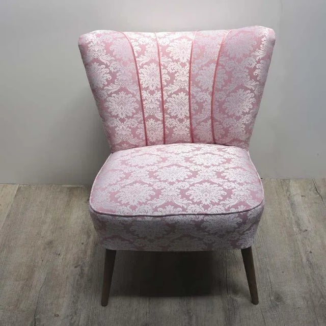 - Vintage cocktail chair reupholstered in pink - Small slanted wooden legs underneath