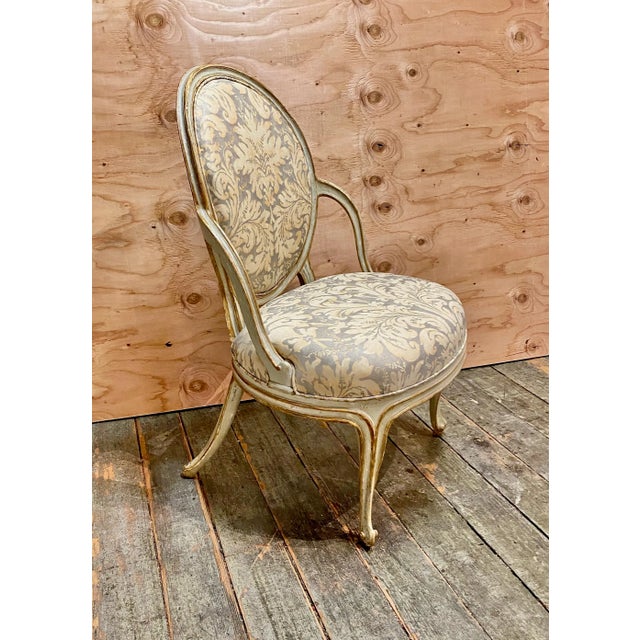 This is an exceptional pair of Adam Style George III, c. 1780 painted and gilt open arm chairs. The chairs are newly...