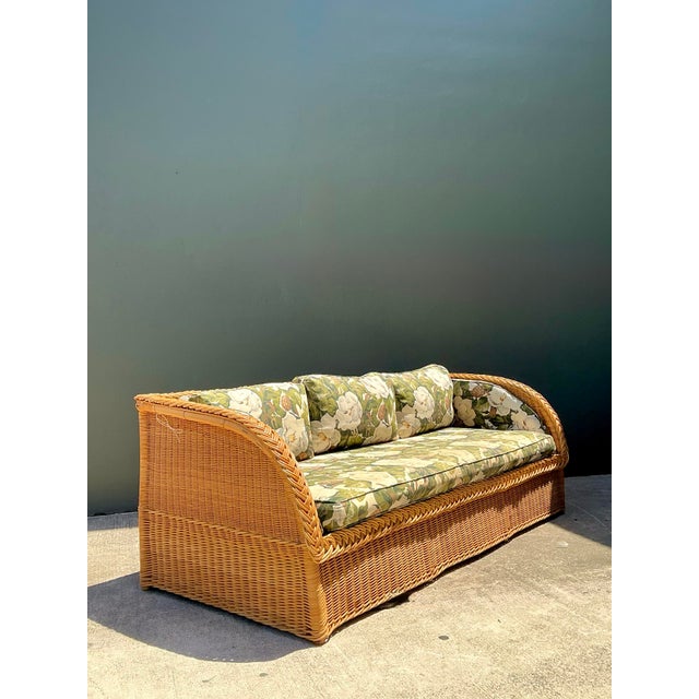 Embrace the effortless elegance of Palm Beach style with this stunning vintage braided rattan sofa. A definitive example...