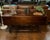 This is a vintage antique drop-leaf sofa table sometimes referred to as a console table. It features hinged side panels...