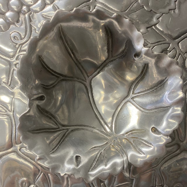 Beautiful chip and dip bowl by Arthur Court can add flair to any table. Has a great grapevine pattern