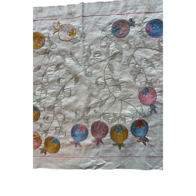 Hand-embroidered Suzani panel from Uzbekistan, worked in fine floss on a cream cotton ground. Two winged horses move...