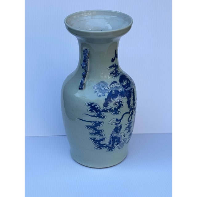 This striking blue chinoiserie vase showcases timeless Eastern elegance, richly adorned with intricate hand-painted motifs...