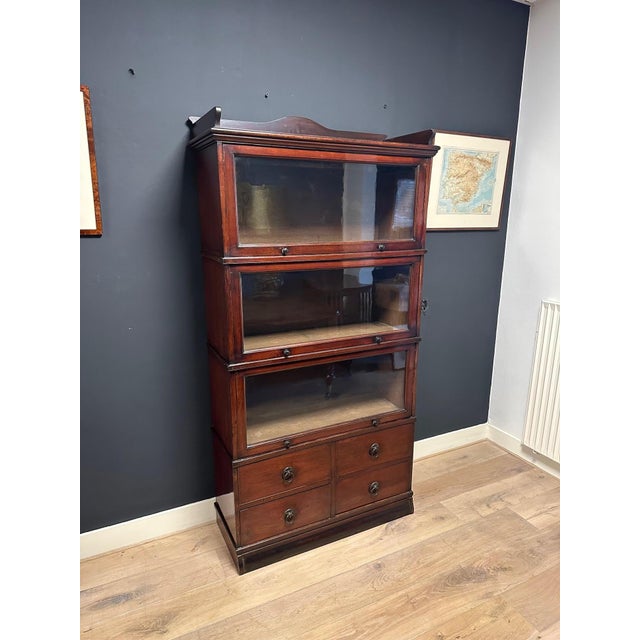 Beautiful antique teak colonial bookcase in Globe Wernicke style. It is a stackable cabinet consisting of six sections....