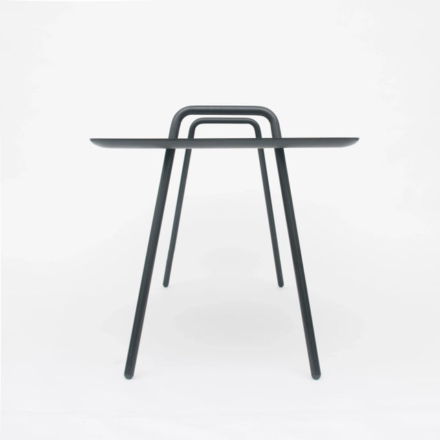 The table or desk&nbsp;AGRAFE&nbsp;is a piece of furniture simply composed of 3 elements. Two curved powder-coated steel...