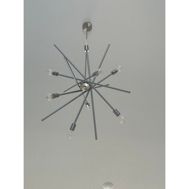 Brand new silver entryway/foyer chandelier from Scott Felder Homes. Never used or installed. Features a modern sputnik-...
