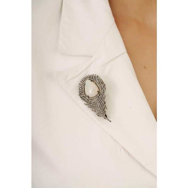 This striking 10.9 carat opal and diamond moonlit brooch pendant is crafted in 925 sterling silver. Featuring a luminous...