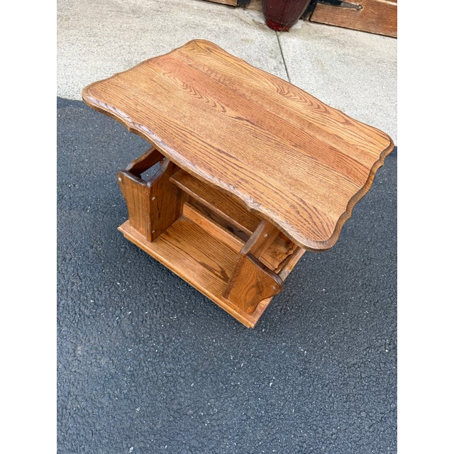 Solid 1980s Oak Vintage end table (with 4 wheels) features a decorative scalloped edge top and built-in side magazine rack...