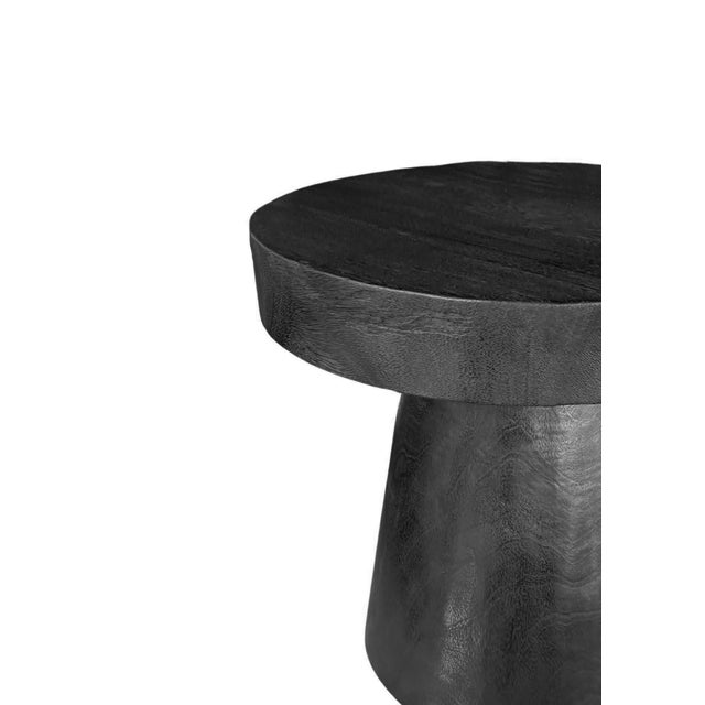 Crafted from solid mango wood, this round side table is a striking celebration of natural material and artisanal...