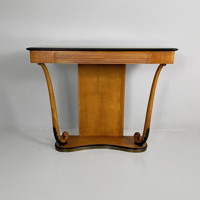 Italian Art Deco consolle in wood and glass, 1930s Console table made of wood with black details. The rectangular top...