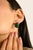 Elevate your look with these striking oval-cut stud earrings, featuring a vivid green center framed in a sleek black and...
