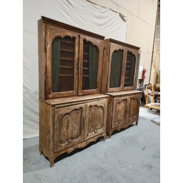 This monumental mid-20th century French Provincial bibliothèque is a striking architectural wall installation, standing...