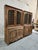 This monumental mid-20th century French Provincial bibliothèque is a striking architectural wall installation, standing...