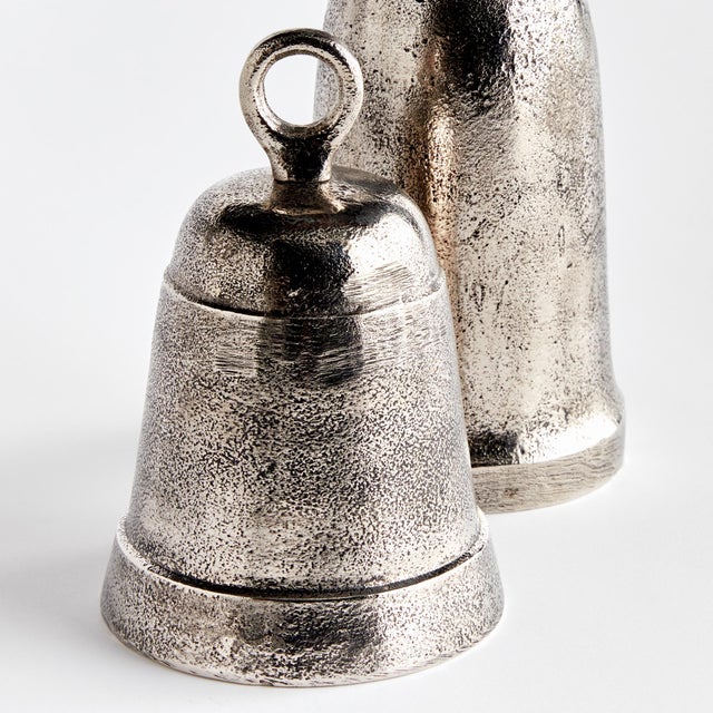 This pair of oldfashioned objets are sandcasted by hand. Their simple, historic profiles are actually functional bells....