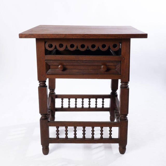 One drawer square table with cutouts and stretcher base. Beautiful carvings. Great for a side table.