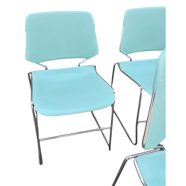 Seven stacking seafoam seats ready for sitting. These are Krueger matrix chairs- plastic and chrome with Mid-century...