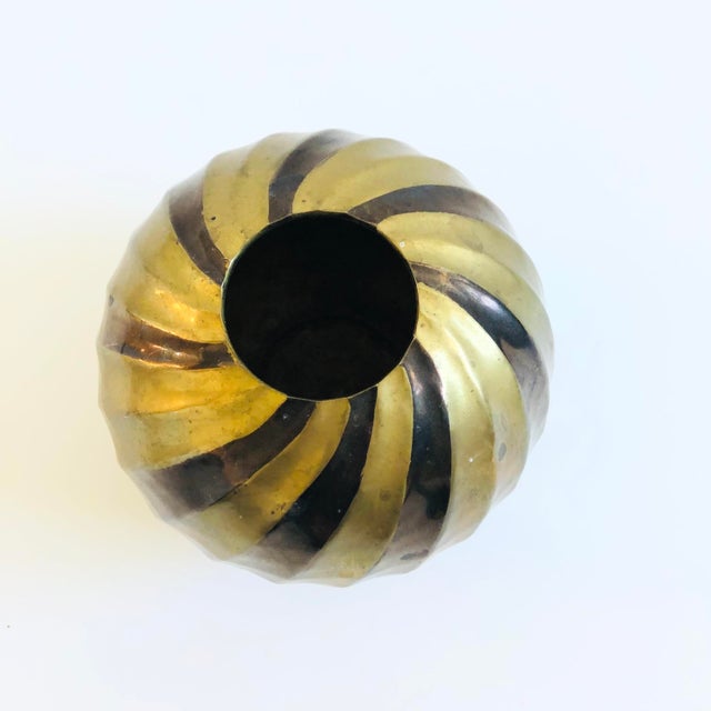 A vintage brass vase with an embossed design to the surface. Lovely sphere shape and detailing with interchanging bands of...