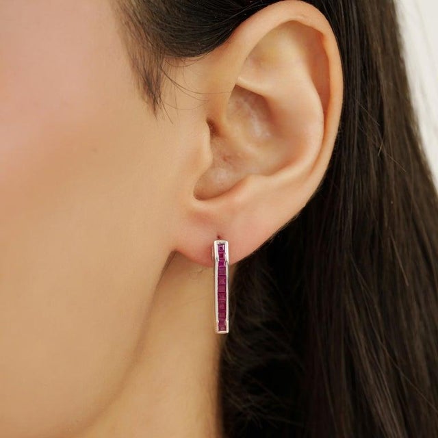 These elegant earrings are crafted in 925 sterling silver and feature a refined linear design set with natural square-cut...