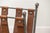 Wrought iron magazine rack in a "U" shape with natural leather straps. Attractive patina on the metal and leather.
