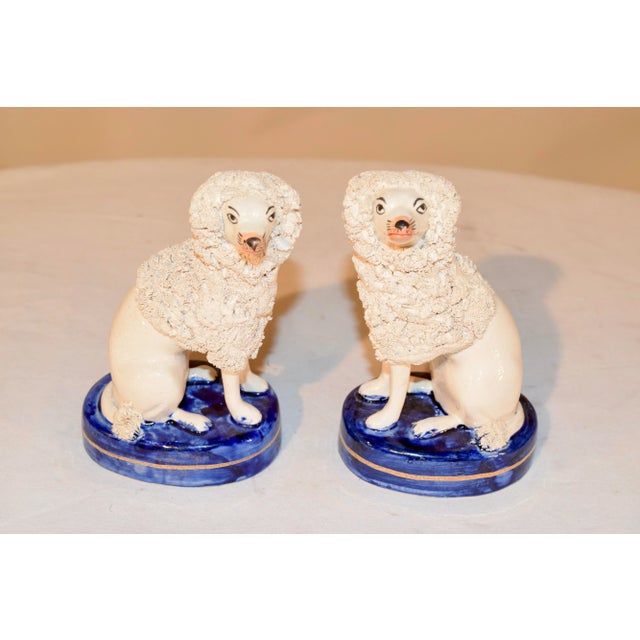 Pair of vintage English poodle figures made in Staffordshire, England in the mid 20th century. Lovely flocking accents and...