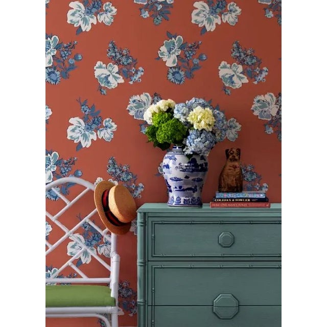 A sample of Swans Island Lacquer Red Wallpaper Care Instructions: Wipe with damp cloth.