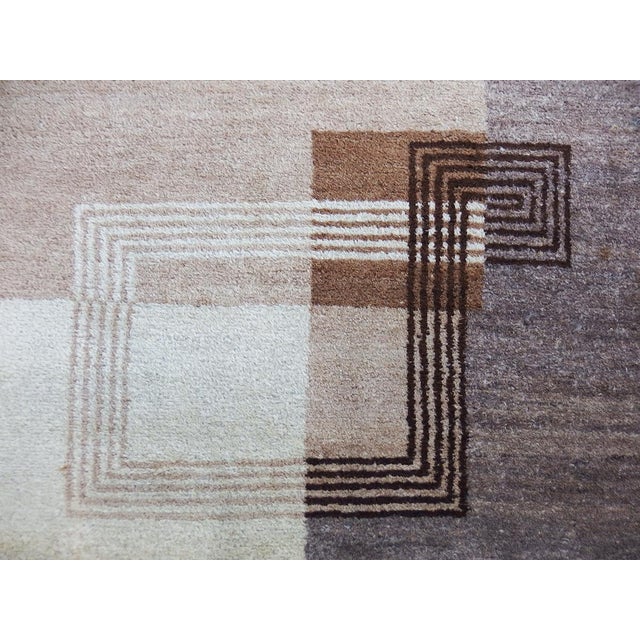 Wool rug with modernist patterns and slightly mottled natural colors in the brown parts. In the style of Ivan Da Silva...