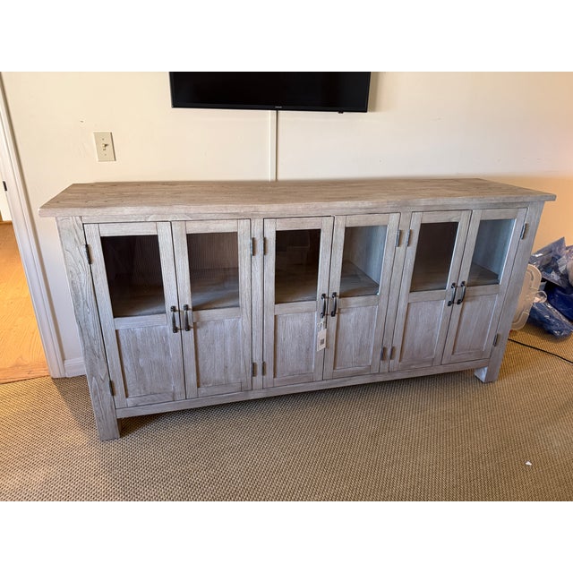 A beautifully proportioned modern farmhouse sideboard crafted in a light oak finish, featuring clean architectural lines...