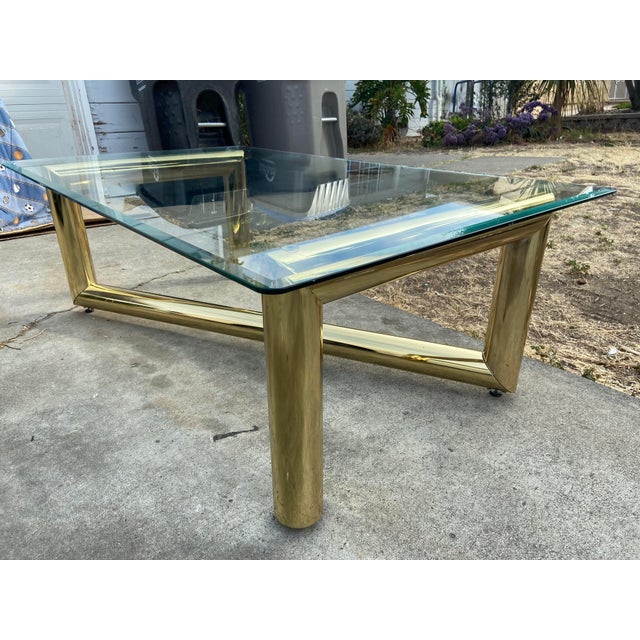 Karl Springer Hollywood Regency Style MCM Brass Tubular Coffee Glass Table is a vintage piece with a touch of glamour....
